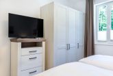 Schlafzimmer "1" mit Kleiderschrank und TV